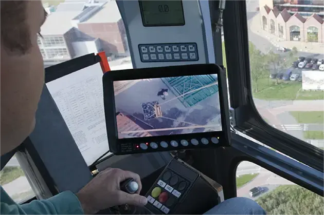 This is a photo of a tower crane operator with the LoadView camera system in action
