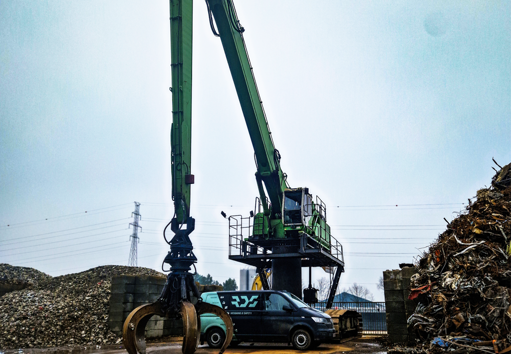 This is a material handler in the recycling sector, with a mounted LoadEx 100 weighing system from RDS Weighing & Safety, and the RDS van in the background.