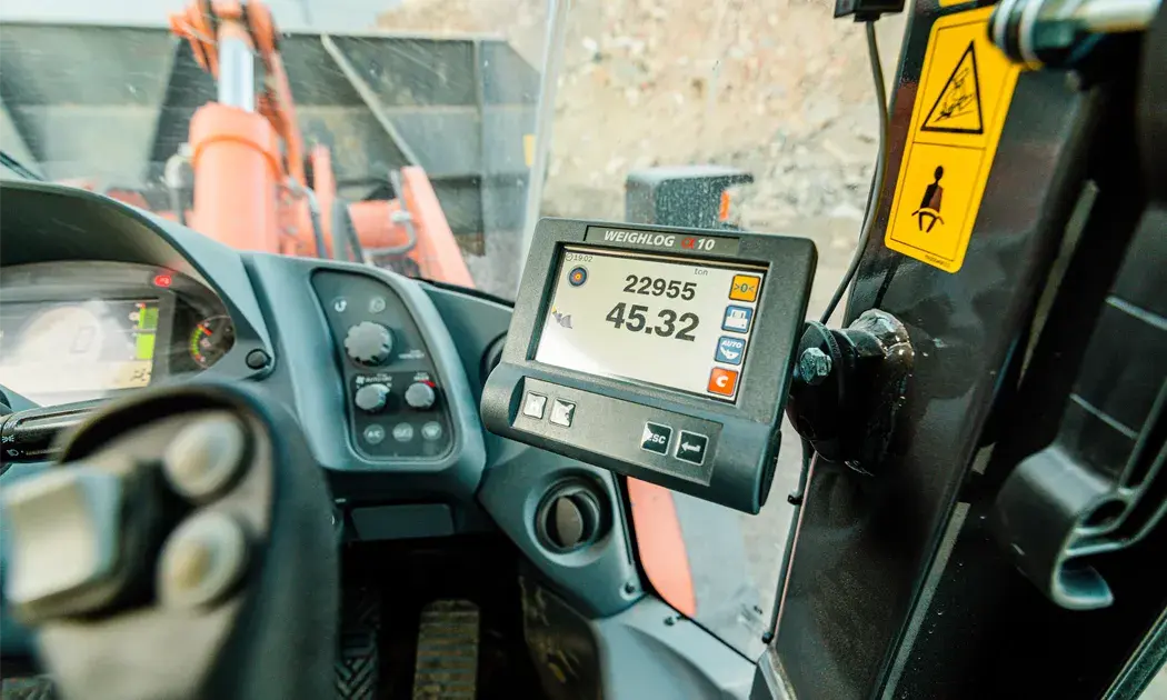 This is an onboard weighing system Weighlog Alpha 10 mounted in a wheel loader